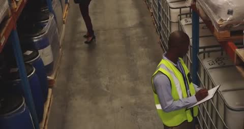 Warehouse Worker Doing Inventory Inspection in Storage Bays