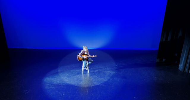 Lone Musician Performing on Stage with Acoustic Guitar - Download Free Stock Images Pikwizard.com