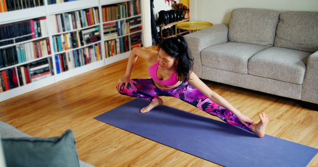 Woman Practicing Yoga in Comfortable Home Living Room Setting with Bookshelf - Download Free Stock Images Pikwizard.com