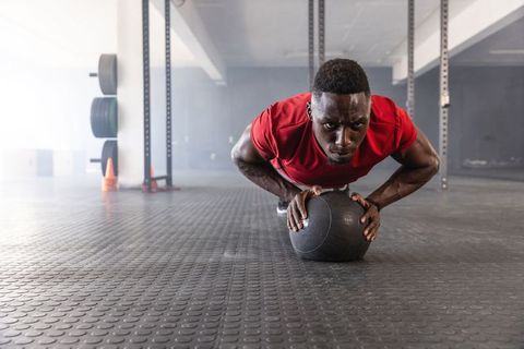 African american athlete doing medicine ball pushups building core strength and stability