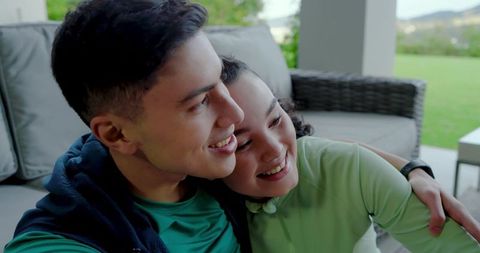 Couple Enjoying Relaxing Moment on Patio Sofa