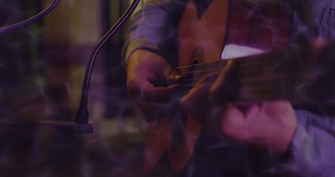 Guitarist Performing Live with Focus on Acoustic Strumming