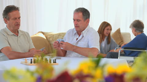 Elderly Friends Enjoying Card Game at Home