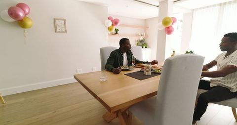 Friends Enjoy Festive Meal Together in Bright Dining Room