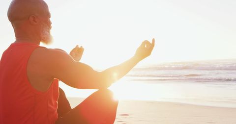 Serene Senior Man Meditating on Beach at Sunset - Download Free Stock Images Pikwizard.com