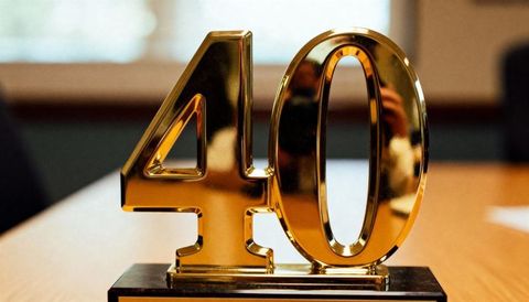 Golden 40 anniversary trophy on glossy black base celebrating corporate milestone