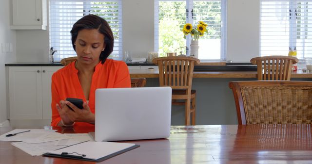 Woman with Phone Managing Finances at Home Office - Download Free Stock Images Pikwizard.com