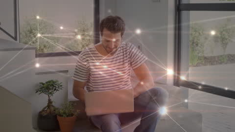 Man using laptop with glowing network connections