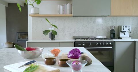 Modern marble countertop meal prep with colorful vegetables, avocado, red cabbage, bowls