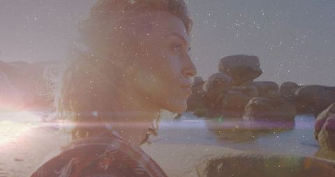 Woman with Wavy Hair Gazing at Tidal Waters During Golden Hour