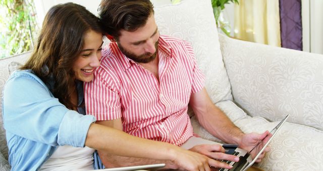 Happy Couple Using Laptop Together on Comfortable Sofa - Download Free Stock Photos Pikwizard.com