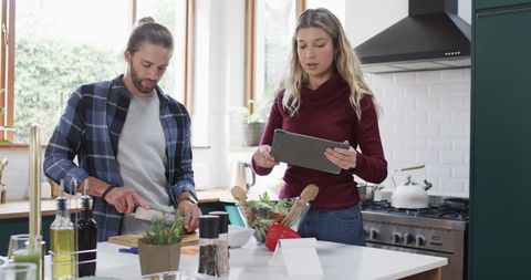 Couple Preparing Healthy Dinner Using Tablet for Recipe in Modern Kitchen - Download Free Stock Images Pikwizard.com