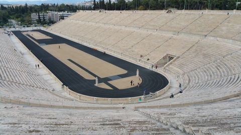 Historic Greek Stadium with Tourists Exploring Ancient Architecture