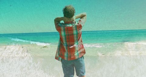 Man Relaxing Facing Ocean on Scenic Beach