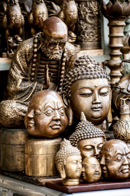 Bronze Buddhist Statue Collection with Various Buddha Heads - Download Free Stock Photos Pikwizard.com