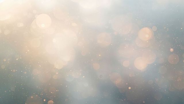 Ethereal teal and warm gold bokeh background with luminous sparkle and soft glow