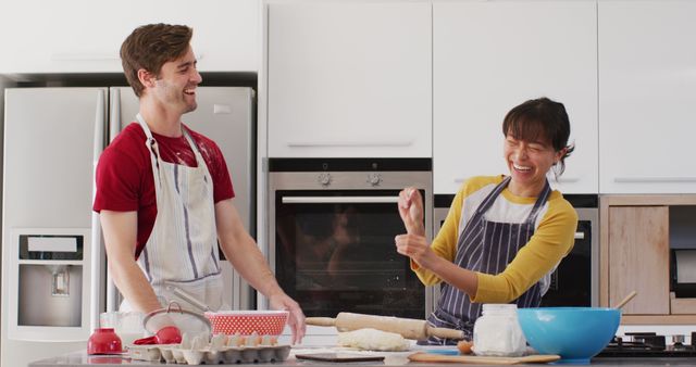 Image of happy diverse couple baking together in kitchen. Love, relationship and spending quality time together concept.