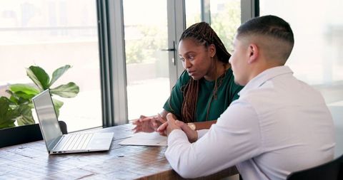 Diverse Colleagues in Collaborative Office Discussion Meeting