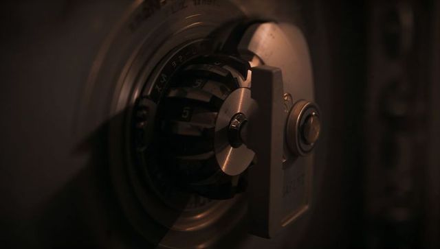 Close-up capturing combination dial, numbered rings and locking cam on vintage vault door