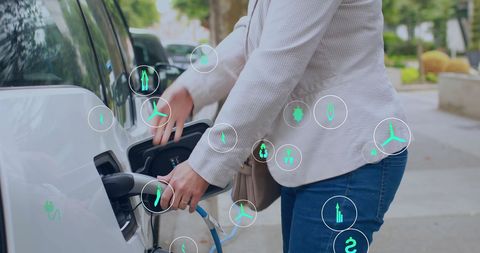 Woman charging electric car with eco-friendly icons overlay