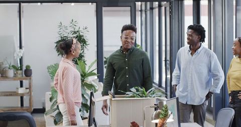 Diverse team celebrates success in modern office environment