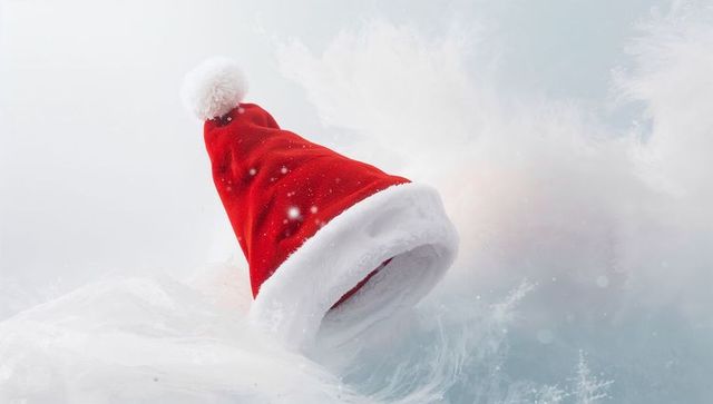 Red Santa Hat with White Fur Trim Floating on Frosty Winter Background with Snow Specks