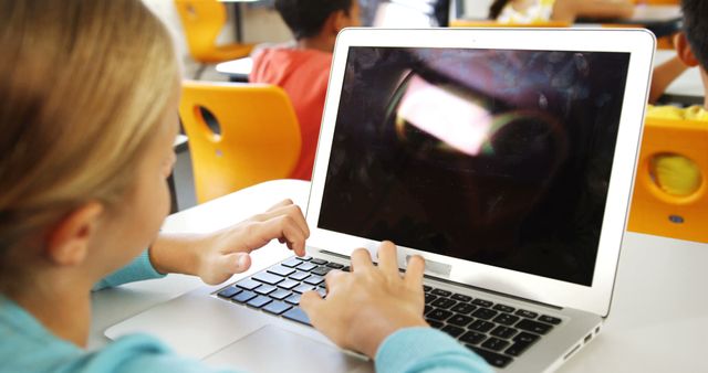 School Child Using Laptop in Classroom Setting - Download Free Stock Images Pikwizard.com