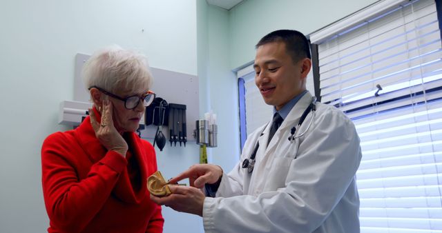 Senior Woman Consulting with Doctor about Ear Health in Clinic - Download Free Stock Images Pikwizard.com