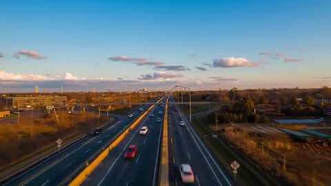 Drone Filming Multilane Highway at Golden Hour Showing Flowing Traffic and Motion Blur