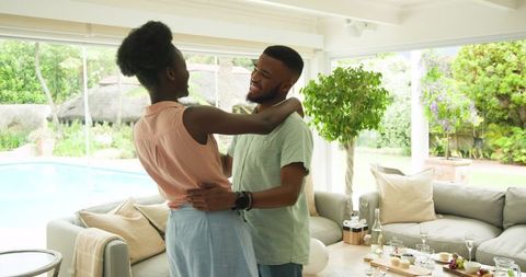 Happy Couple Dancing in Cozy Living Room at Home