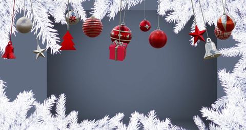 Festive Christmas Ornaments Hanging from Snowy Fir Branches