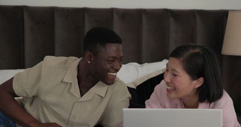 Diverse Couple Shopping Online with Laptop
