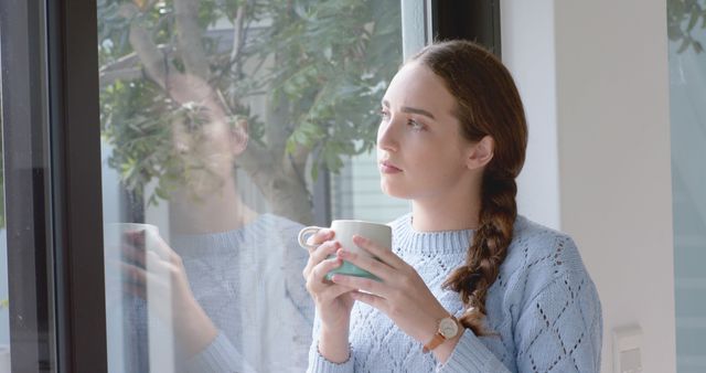 Reflective Woman Holding Mug by Window - Download Free Stock Images Pikwizard.com