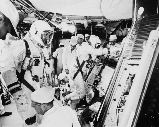 S65-56155 (15 Dec. 1965) --- Astronauts Thomas P. Stafford, pilot; and Walter M. Schirra Jr., command pilot, are readied for insertion into the Gemini-6 spacecraft in the White Room at Pad 19, Cape Canaveral, Florida. Photo credit: NASA or National Aeronautics and Space Administration
