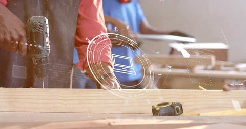 Carpentry team working with drill and holographic interface in modern woodworking shop