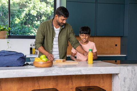 Father and Son Preparing Breakfast in Cozy Modern Kitchen