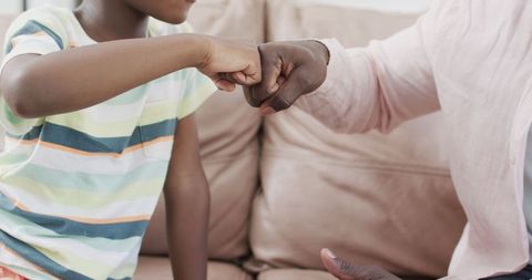 Father and Son Fist Bump Shows Connection at Home