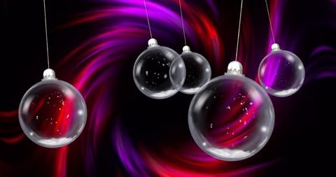 Glowing Christmas Baubles with Light Trails on Black Background