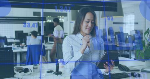 Businesswoman Analyzing Data with Digital Overlays in Modern Office