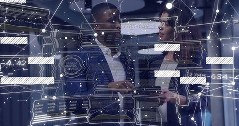 Colleagues analyzing data in futuristic server room