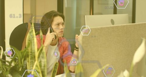 Frustrated office worker on call with digital icons and greenery