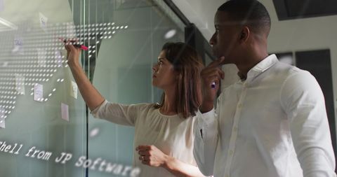 Team Collaborating with Digital Overlay on Glass Wall