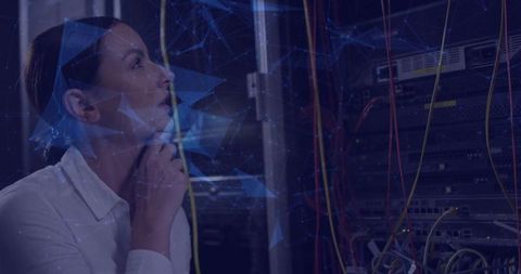 IT Specialist Studying Network Racks with Data Visualization Overlay in Dim Server Room