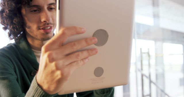 Young Adult Using Tablet Indoors with Natural Light - Download Free Stock Images Pikwizard.com