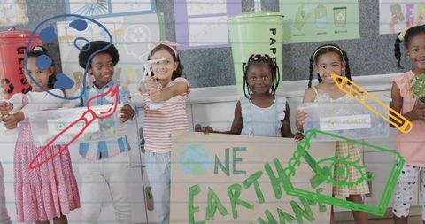 Children holding one earth sign while sorting recycling bins and teaching green awareness