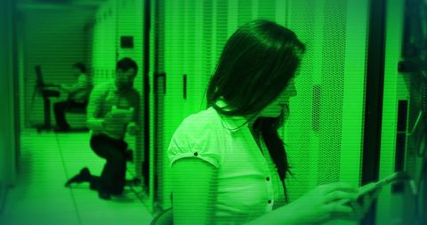 Technicians troubleshooting in data center with digital interference