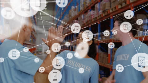 Diverse Volunteers Collaborating in Warehouse with Digital Network