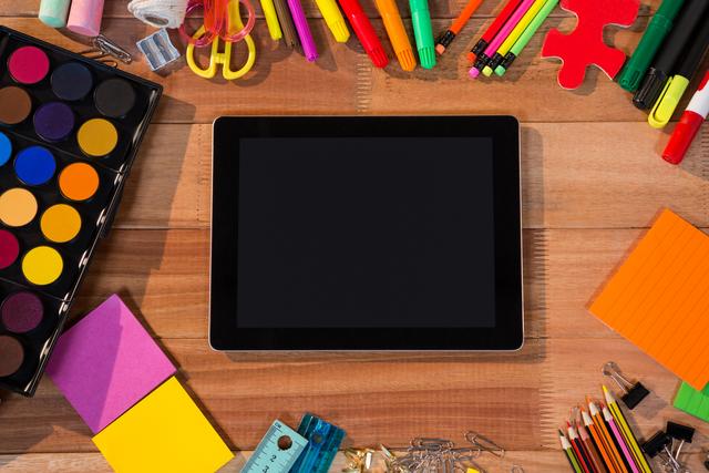 Digital Tablet Surrounded by Colorful Stationery on Wooden Table - Download Free Stock Photos Pikwizard.com