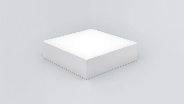 Minimal white pedestal cube on pale gray reflective surface for product display
