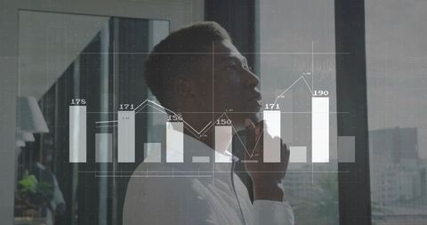 Business Professional Analyzing Data Overlaid with Analytical Chart